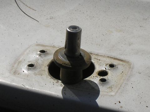 1990 Ford Bronco - Detail of a metal post and its mounting plate, likely a vehicle component.