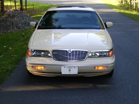 1996 Mercury Grand Marquis - Front view of a cream/beige Mercury Grand Marquis sedan with chrome waterfall grille, amber turn signals illuminated, and a Maryland front…