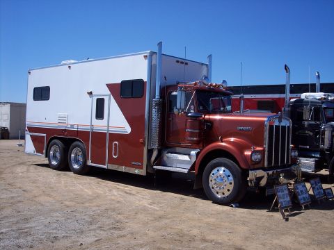 1981 Kenworth W900A - A custom 1981 Kenworth W900A truck with a sleeper cab is parked outdoors next to another truck.