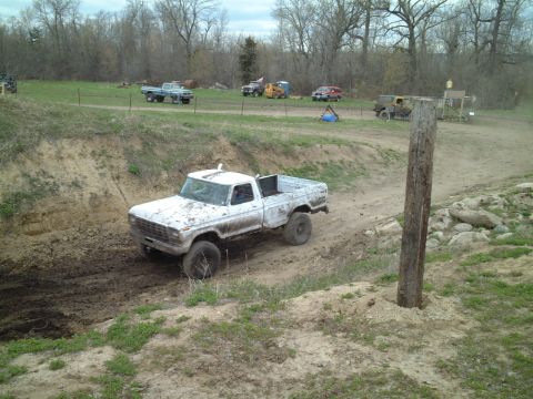 1979 Ford F-150 - A white 1979 Ford F-150 navigates a muddy track in an off-road park.