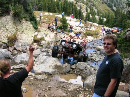 1995 Ford Bronco - Off-road vehicles tackle a challenging rocky terrain in a mountainous area.