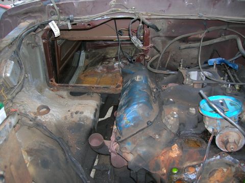 1978 Ford F-250 - The engine bay of a 1978 Ford F-250 shows significant wear and tear, with visible rust and grime.
