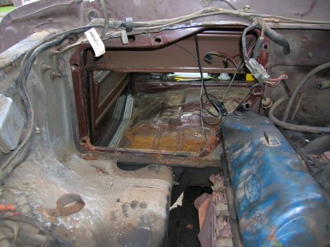 1978 Ford F-250 - The engine bay and firewall of a vehicle are exposed, revealing wiring, engine components, and the interior floor.