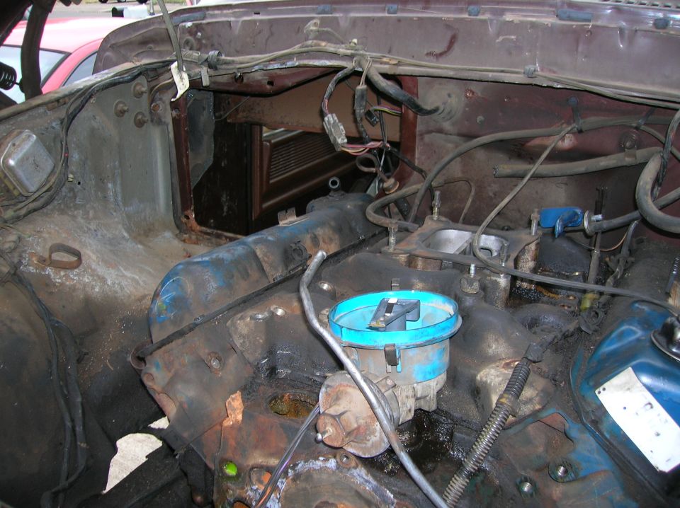 Engine bay of a 1978 Ford F-250, showing the distributor and carburetor