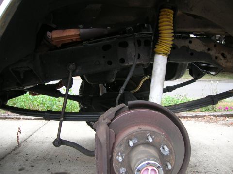 1978 Ford F-250 - Undercarriage view of a truck's suspension system, highlighting the brake assembly and shock absorber.