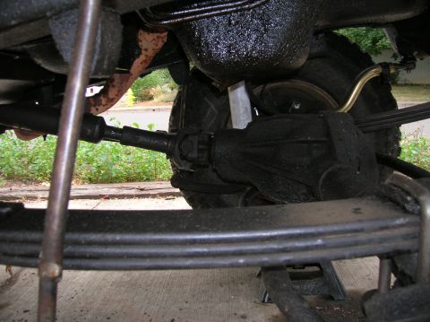 1978 Ford F-250 - Close-up view of the undercarriage components of a truck, including the rear axle and suspension system.