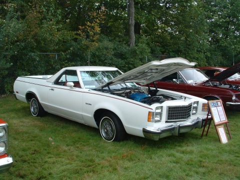 1973 Ford Ranchero - A white 1977 Ford Ranchero is displayed with its hood open, alongside other vehicles.
