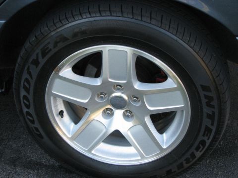 1985 Mercury Grand Marquis - A close-up view of a vehicle's wheel and tire, showing the tread pattern and alloy rim details.