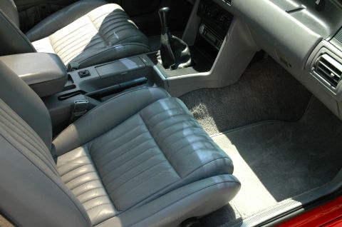 1993 Ford Mustang - The interior of a 1993 Ford Mustang features gray leather seats and a manual shifter.