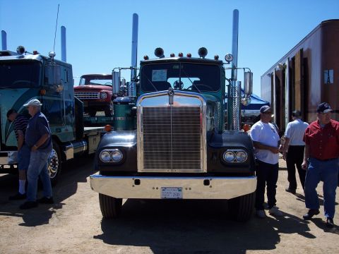 1981 Kenworth W900A - A 1981 Kenworth W900A truck is displayed at an outdoor event, with other vehicles and people around.