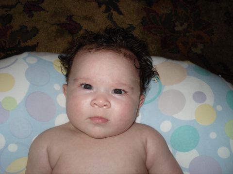2000 Ford Crown Victoria - Close-up of a baby's face with dark curly hair and wide eyes.