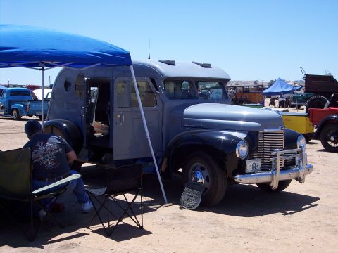1981 Kenworth W900A - This vintage truck, likely a 1947 International KB-6, is displayed with its doors open and a sign in front.
