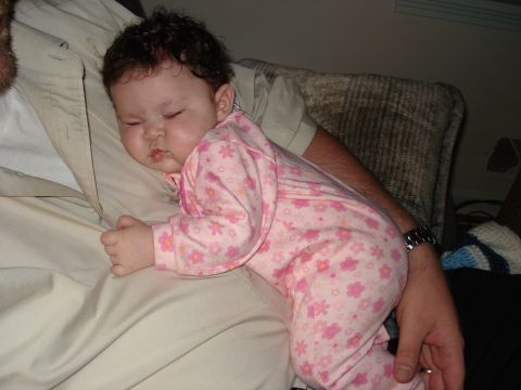 2000 Ford Crown Victoria - A baby sleeps soundly while being held by an adult.