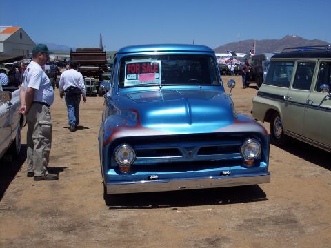 1981 Kenworth W900A - A blue 1955 Ford F-100 pickup truck is for sale at an outdoor event.