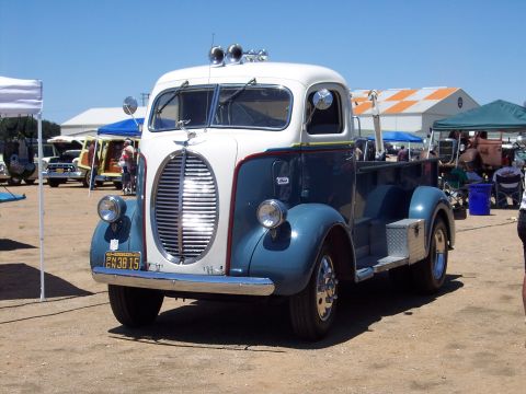 1981 Kenworth W900A - A vintage truck with a distinctive grille and dual headlights is parked outdoors at an event.