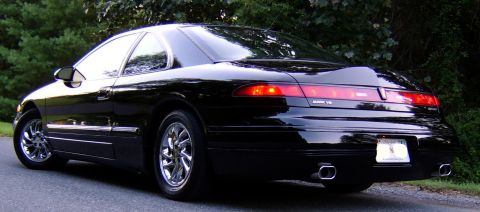 1996 Mercury Grand Marquis - Rear 3/4 view of a black coupe, identified as a Mark VII by its badging.