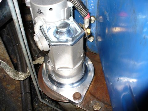 1978 Ford Bronco - Close-up of a newly installed starter motor on a vehicle engine.