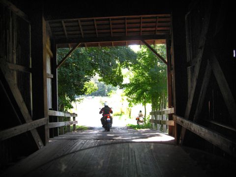 1979 Ford Bronco - Riding through a rustic covered bridge on a bright, sunny day.