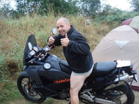 1979 Ford Bronco - A man poses on a motorcycle with tents set up in the background.