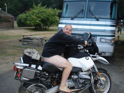 1979 Ford Bronco - A man sits on a motorcycle with an RV parked behind him.