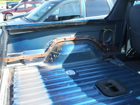 1990 Ford Bronco - Driver rear panel view - carpet gone and trim panel gone.