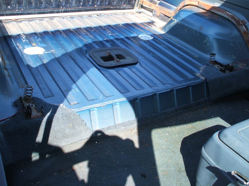 Another view - rear carpet and trim panels gone - no rust.  Still have to pull mounting brackets and rails yet...