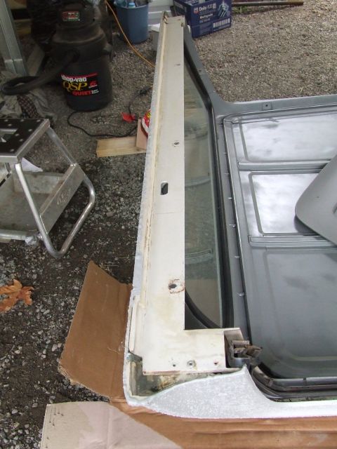 1979 Ford Bronco - Close-up of a car door frame, showing interior metal and exterior trim details.