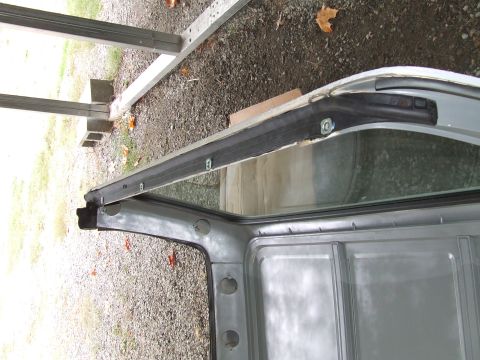 1979 Ford Bronco - Detail of a vehicle's door frame and window seal, possibly undergoing repair or restoration.