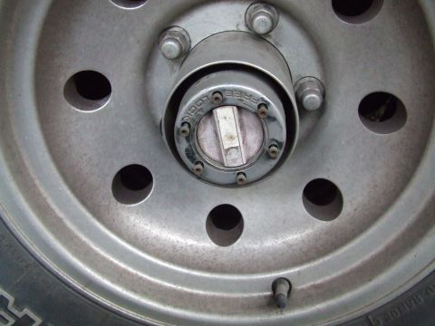 1979 Ford Bronco - Close-up of a wheel hub with a manual locking mechanism.
