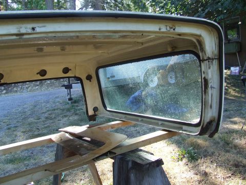 1979 Ford Bronco - Vehicle hardtop removed and placed on sawhorses for repair or storage.