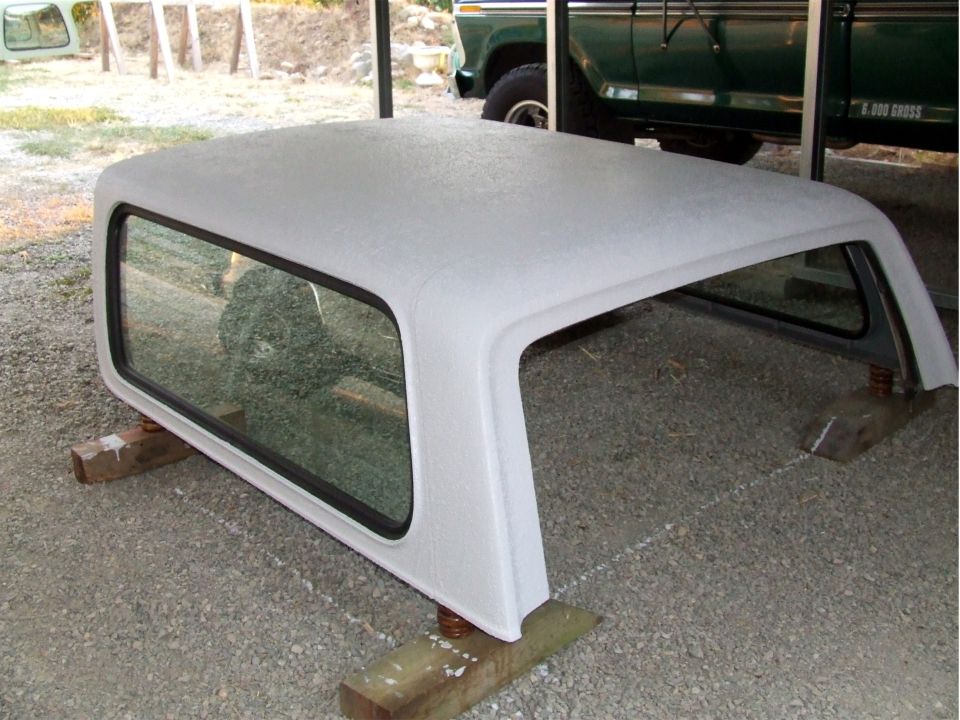 White camper shell with tinted windows