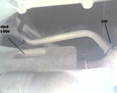 1990 Ford Bronco - Close-up view of the vehicle's stock y-pipe and exhaust components.