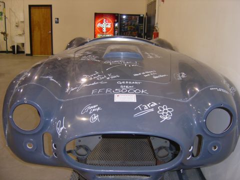 1996 Ford Bronco - A gray car hood, covered in signatures and the text FFR5000K, is displayed indoors.