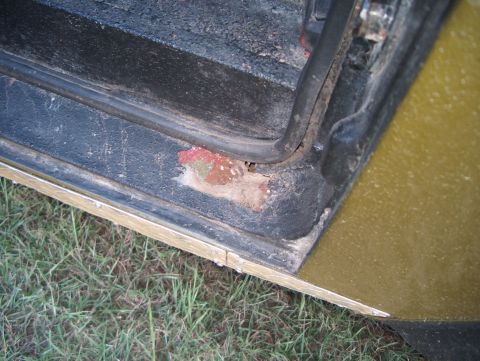 1979 Ford Bronco - Close-up view of a vehicle's door jamb, showing signs of rust and wear.