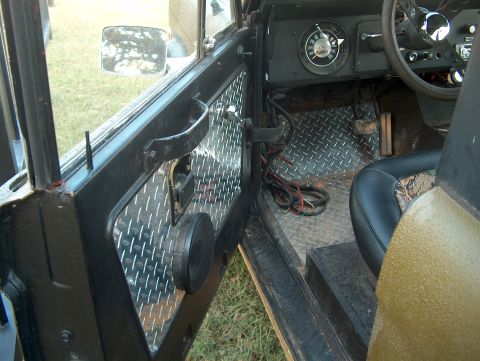 1979 Ford Bronco - The interior of a 1979 Ford Bronco features custom diamond plate door panels and flooring, along with a unique seat design.