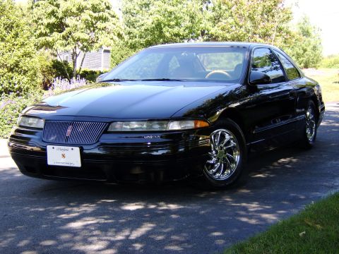 1996 Mercury Grand Marquis - A black 1993 Lincoln Mark VIII is shown from a three-quarter front view, chrome wheels and a distinctive grille.