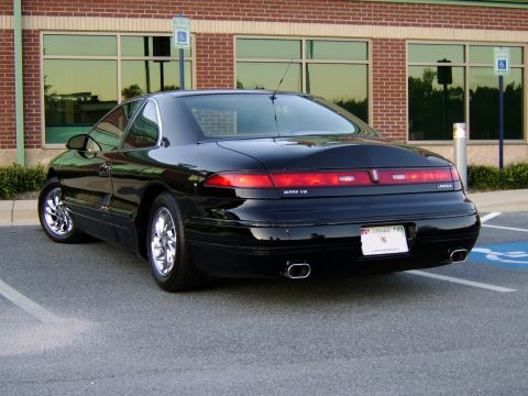 1996 Mercury Grand Marquis - Rear view of a black Lincoln Mark VIII parked in a lot.