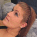 1987 Suzuki Samurai - A woman with auburn hair pulled back in a ponytail is captured in profile, her gaze directed upwards.