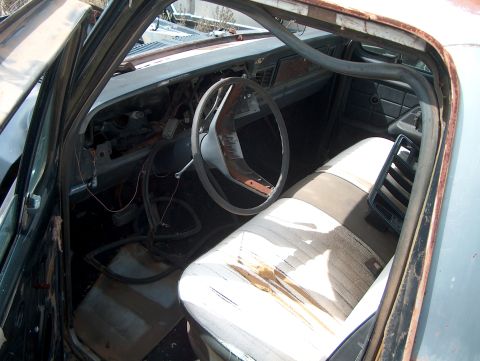 1979 Ford Bronco - The interior of a worn-out 1978 Ford Bronco shows signs of significant disrepair and neglect.