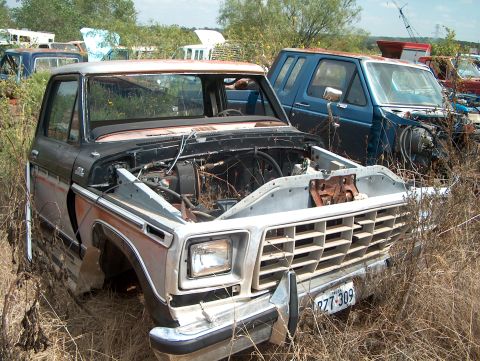 1979 Ford Bronco - Junkyard scene with a derelict 1978 Ford Bronco and other vehicles.