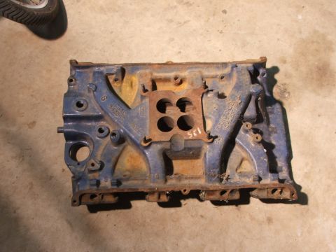 1965 Ford Mustang - A blue engine block with visible casting numbers sits on a concrete surface.