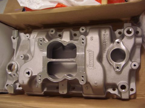 1974 Ford Bronco - Summit intake manifold for a V8 engine, showing dual carburetor openings and part number details.