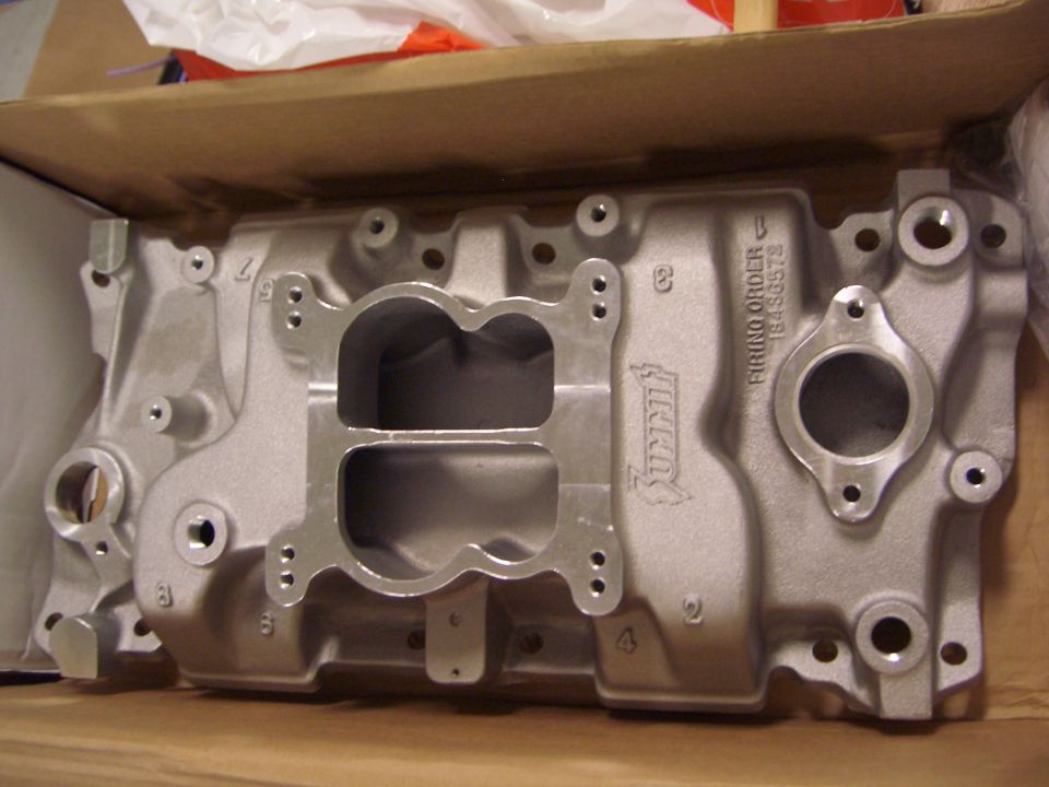 Summit intake manifold with dual carburetor openings and firing order 18436572 stamped on it