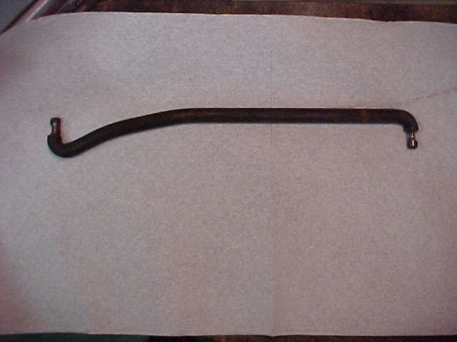 A long curved metal tube or hose laid diagonally on a sheet of paper