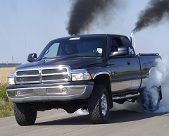 2002 Dodge 2500 - 2002 Dodge 2500 pickup truck performing a "roll coal" maneuver, emitting excessive black smoke.
