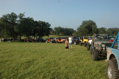 2001 Jeep Wrangler - A group of Jeeps are gathered in a field on a clear day.