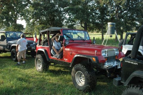 2001 Jeep Wrangler - Multiple Jeeps gathered outdoors, with one red Jeep prominently displayed in the foreground.