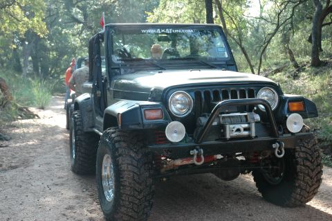 2001 Jeep Wrangler - Off-roading in a 2001 Jeep Wrangler on a wooded trail with another vehicle following.
