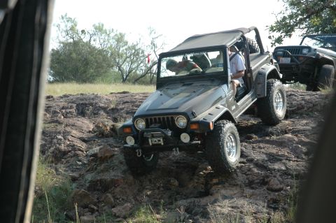 2001 Jeep Wrangler - Two Jeeps navigate a rocky trail under a clear sky.