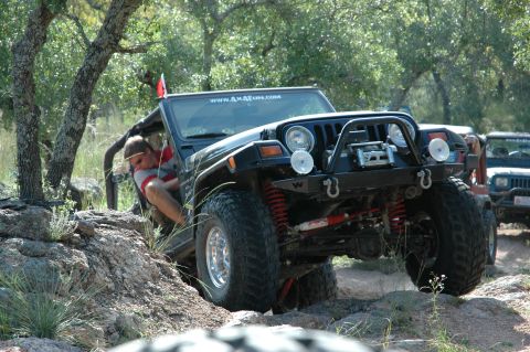 2001 Jeep Wrangler - A black 2001 Jeep Wrangler tackles a challenging off-road course, its capabilities.